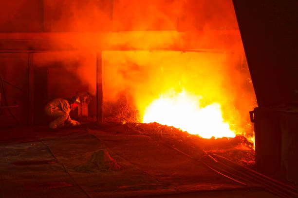 iron works blast furnace taphole spewing molten iron, closeup of photo