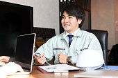 Asian office worker wearing work clothes and having a meeting in the office