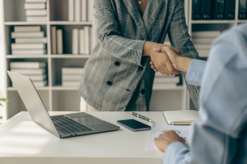 Thank you for letting me be part of the team. Cropped view of two businessmen shaking hands during meeting for success in job interview in business office Thank you partner, close-up photo