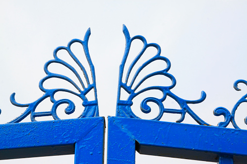 blue wrought iron fence, closeup of photo