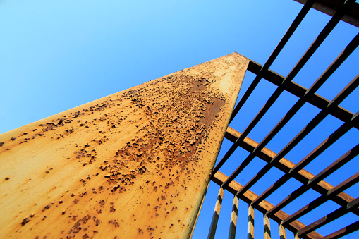 Oxidation rust steel beams in blue sky background, closeup of photo