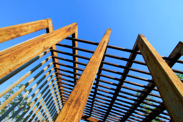 istock Oxidation rust steel beams in blue sky background 1881663761