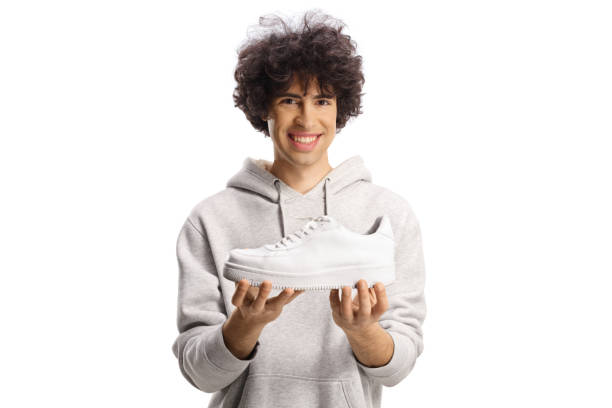 istock Happy young man holding a trendy white sneaker 1881667431