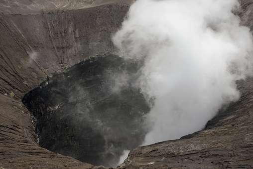 Mount Bromo's crater in Indonesia belches a dense cloud of sulfurous gas, providing a glimpse into Earth's fiery interior