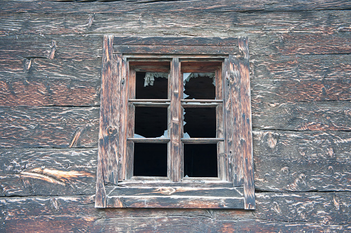 Wooden window on grey brick wall