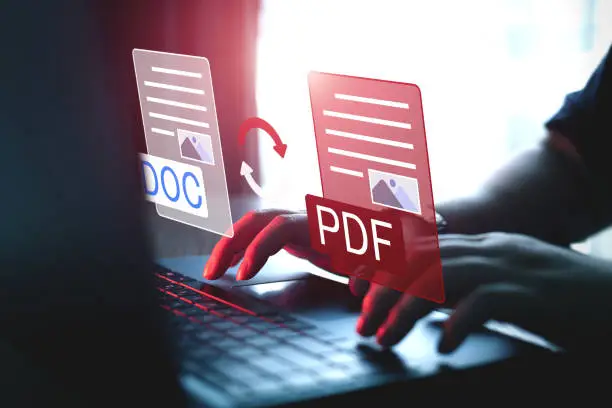 Photo of Convert PDF files with online programs. Users convert document files on a platform using an internet connection at desks.