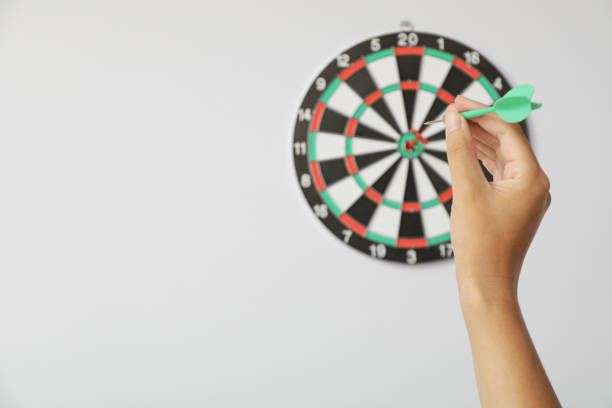 istock Target, dartboard, hitting the center. On a light background, with a wire in his hand. 1881775480