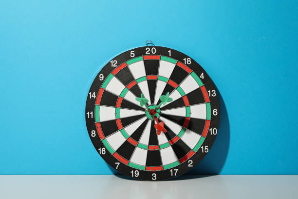 istock Darts hitting the target with wires on a blue background. Close up. 1881778078
