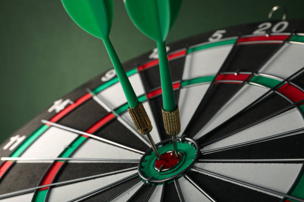 istock Darts hitting the target with wires on a green background. Close up. 1881779123
