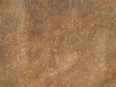 Background of rust flecked color on canvas handmade with acrylic paints
