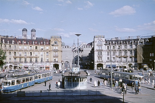 Munich, Bavaria, Germany, 1960. The Karlsplatz (Stachus) in the center of Munich. Also: locals, tram, shop and buildings.