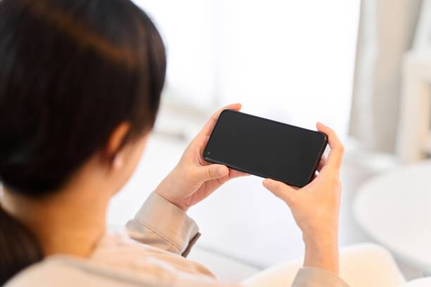 istock Woman watching video on smartphone 1881896540