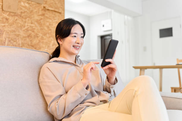 istock Asian woman sending a message on smartphone 1881897047