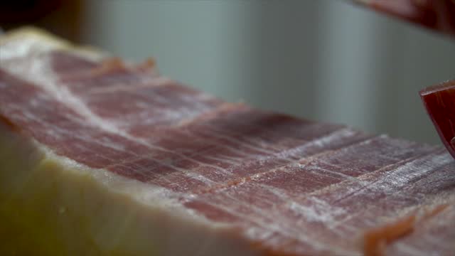 Person slicing serrano ham