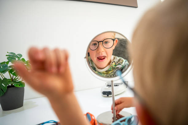istock Young Boy Engaged in Choosing New Glasses at Store 1881981027