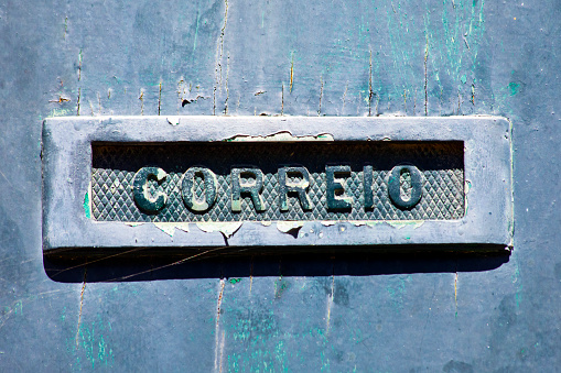 Close-up view of Mail box  on  wooden front door. Portuguese language. Valença do Minho, Portugal.