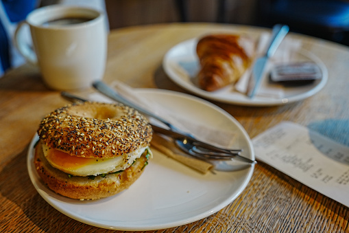 Coffee and bagel with egg (breakfast)