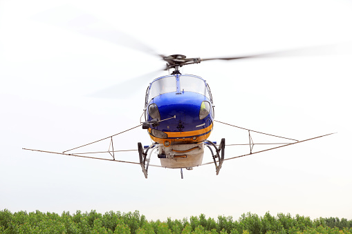 Agricultural helicopters fly in the sky