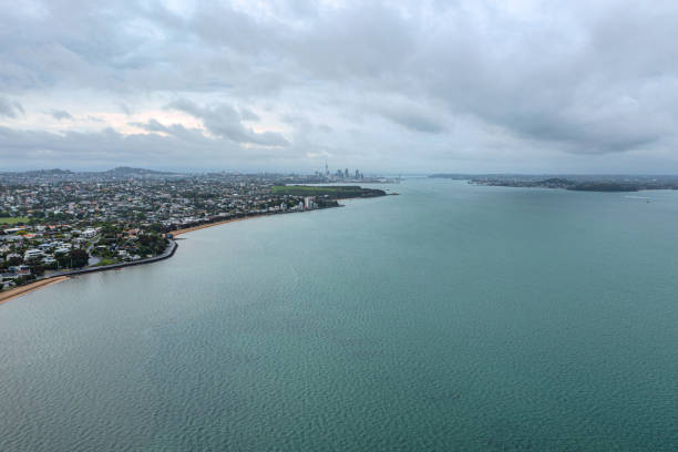 St Heliers Beach and Kohimarama Beach on a cloudy day in Summer with Auckland city far back.