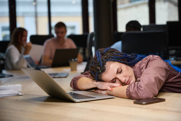 istock Overworked lady resting on working place with laptop 1882112700