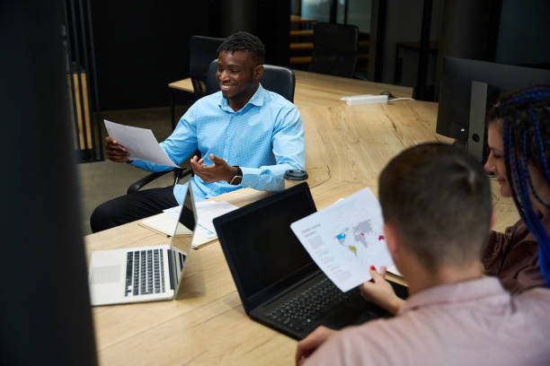 istock African American man and colleagues looking at global trading transfers data 1882114113