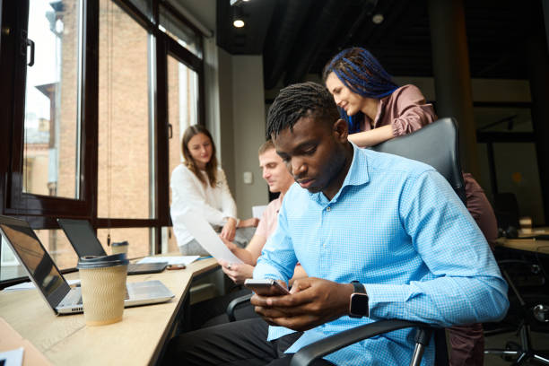 istock Man chatting with friends or playing games during project discussion 1882114355
