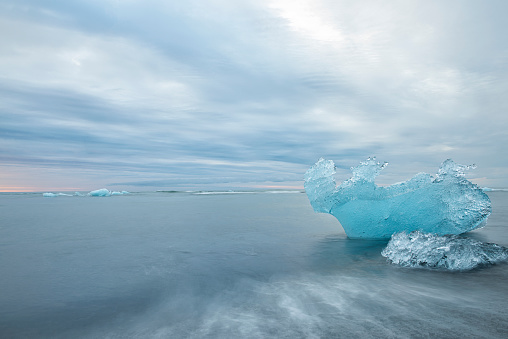 ice floes in the water on the ocean shore at dawn. Jökulsárlón. glacier lagoon in Iceland. Long exposure. Seascape.