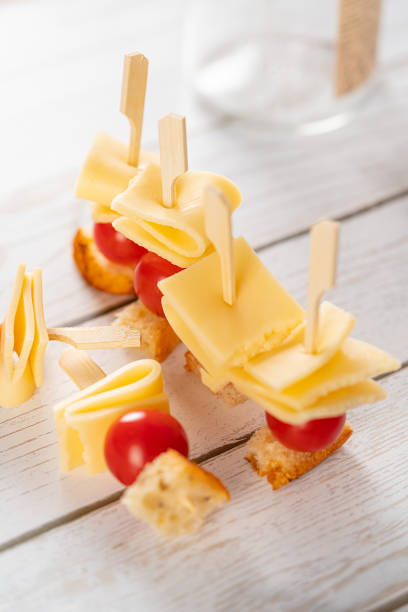 istock cheese canapes with tomatoes on a white wooden background 1882120580