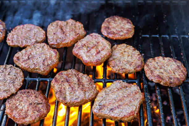 istock Grilling beef meat barbecue burgers on the barbecue grill using a fire flame 1882224555