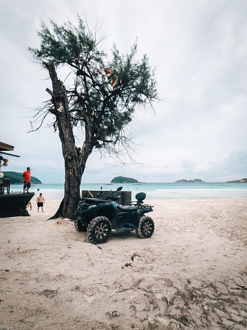 Kuala Terengganu, Malaysia – May 10, 2023: A quad parked by the beach near the resort