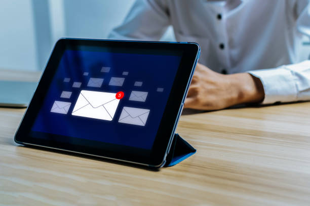 istock digital mobile tablet display with send and receive email notification icon on desk in office, chat message, cyber security, digital marketing, new mail, business finance, internet technology concept 1882263290