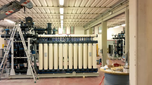 Slow motion view of a reverse osmosis system for water drinking plant. Water purification system, industrial environment from drone