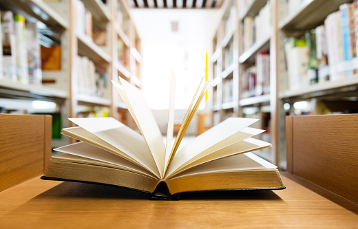 Open book on the desk of library