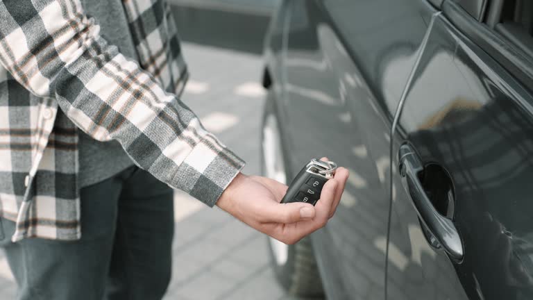 Close-up male hand catching car key in slow motion