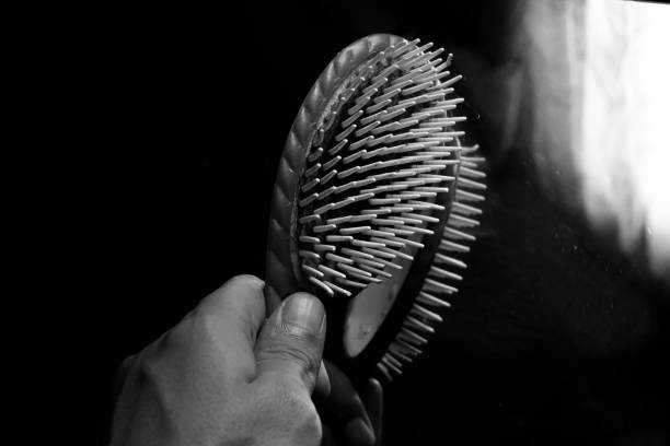 istock A man's hand holds a hair comb. 1882325548