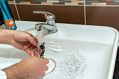 Man Washing the Razor during Shaving