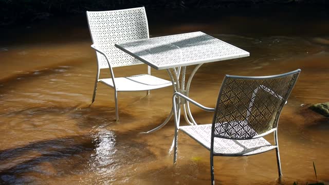 Stream of water are flowing through the tables and chairs