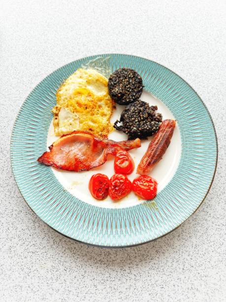 Cooked Irish Breakfast of bacon sausage black pudding tomatoes and fried egg
