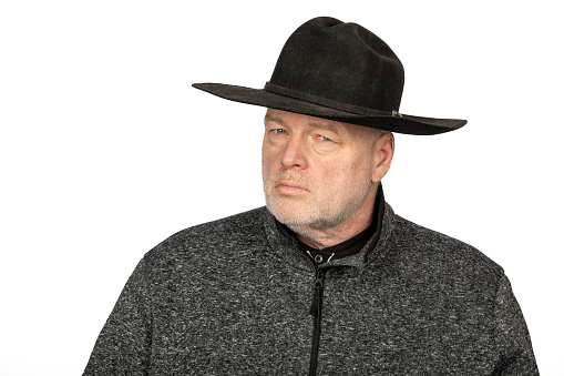 Middle Aged Caucasian Man in Black Cowboy Hat Staring Intensely -  Photo Isolated on White Background