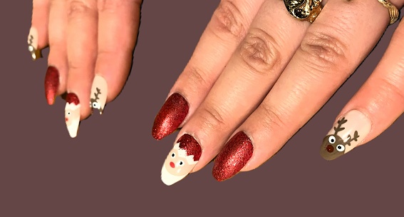 Nail art adorned with festive Christmas decorations.