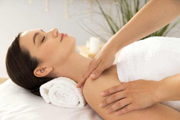 istock Young attractive woman in spa enjoying massage 1882489139