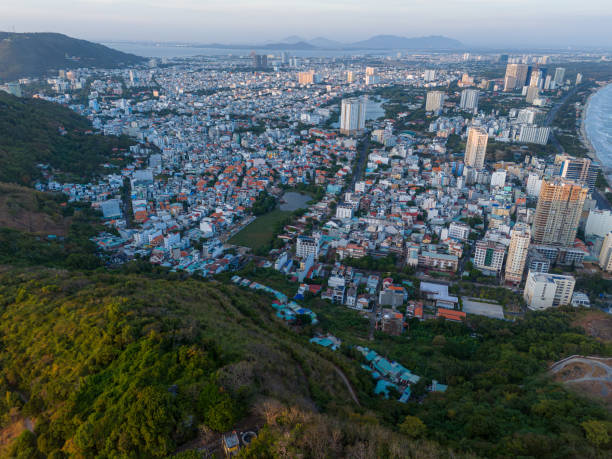 istock Panoramic coastal Vung Tau view from above, with waves, coastline, streets, coconut trees, Mount Nho in Vietnam behind the statue of Christ the King 1882495901