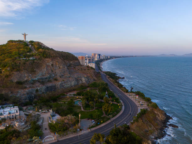 istock Panoramic coastal Vung Tau view from above, with waves, coastline, streets, coconut trees, Mount Nho in Vietnam behind the statue of Christ the King 1882496446