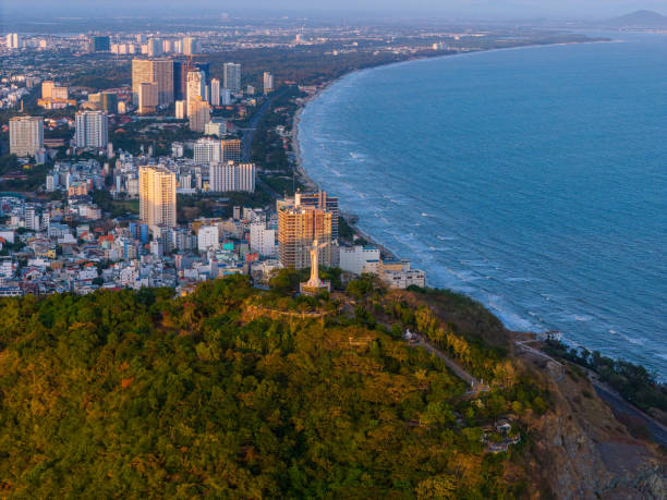 istock Panoramic coastal Vung Tau view from above, with waves, coastline, streets, coconut trees, Mount Nho in Vietnam behind the statue of Christ the King 1882496447