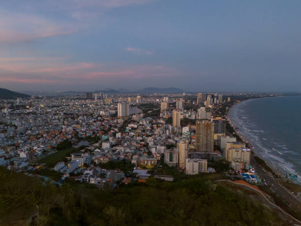 istock Panoramic coastal Vung Tau view from above, with waves, coastline, streets, coconut trees, Mount Nho in Vietnam behind the statue of Christ the King 1882496449