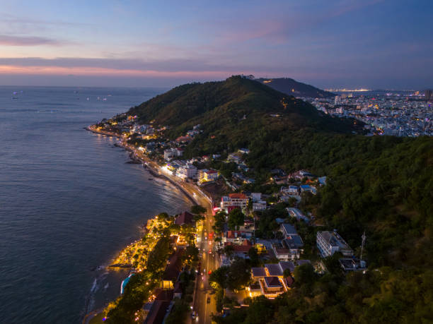 istock Panoramic coastal Vung Tau view from above, with waves, coastline, streets, coconut trees, Mount Nho in Vietnam behind the statue of Christ the King 1882496452
