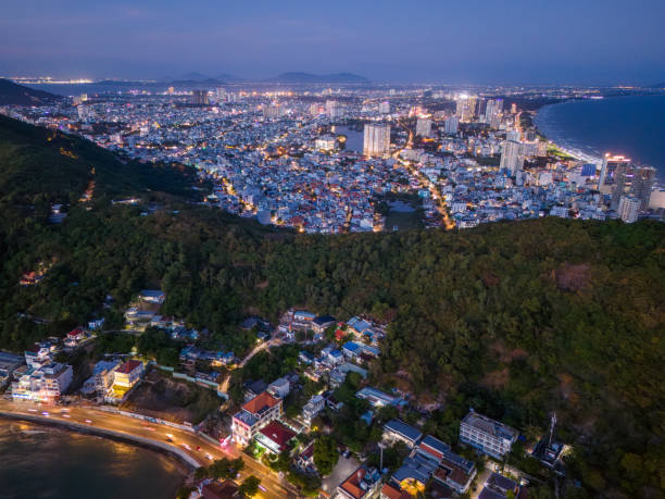 istock Panoramic coastal Vung Tau view from above, with waves, coastline, streets, coconut trees, Mount Nho in Vietnam behind the statue of Christ the King 1882497017