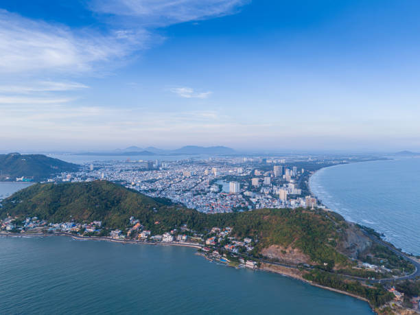 istock Panoramic coastal Vung Tau view from above, with waves, coastline, streets, coconut trees, Mount Nho in Vietnam behind the statue of Christ the King 1882497539