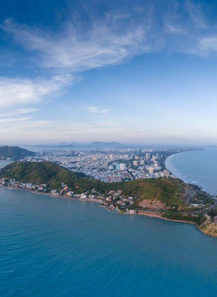 istock Panoramic coastal Vung Tau view from above, with waves, coastline, streets, coconut trees, Mount Nho in Vietnam behind the statue of Christ the King 1882497542