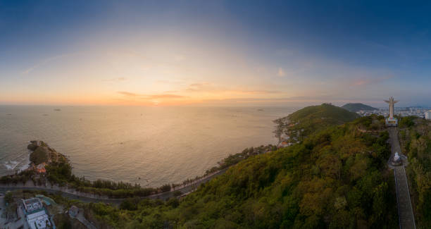 istock Panoramic coastal Vung Tau view from above, with waves, coastline, streets, coconut trees, Mount Nho in Vietnam behind the statue of Christ the King 1882497557